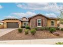 Attractive home with stone accents, a well-maintained front yard, and an inviting facade at 14845 W Georgia Dr, Surprise, AZ 85379