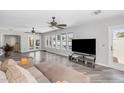 Bright living room with wood floors, ceiling fans and multiple windows at 16224 S 40Th Pl, Phoenix, AZ 85048