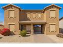 Charming two-story townhome features a desert landscape and covered entryway at 16510 W Tether Trl, Surprise, AZ 85387