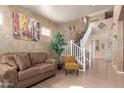 Cozy living room boasts high ceilings and a staircase leading to the second floor at 16510 W Tether Trl, Surprise, AZ 85387