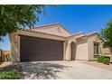 Charming single-story home featuring a two-car garage, neutral stucco, and well-manicured landscaping at 18658 N Desert Willow Dr, Maricopa, AZ 85138