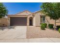 Inviting single-story home with a two-car garage, neutral stucco, and neat landscaping at 18658 N Desert Willow Dr, Maricopa, AZ 85138