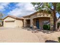 Attractive single-story home with a tile roof, covered entryway, and desert landscaping at 21192 E Stirrup St, Queen Creek, AZ 85142