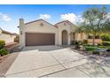 Well-maintained single-story home with a desert landscape, a two-car garage, and a charming entry at 21867 N 263Rd Dr, Buckeye, AZ 85396