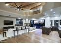 Beautiful living room featuring wood beam ceiling, fireplace and large windows, seamlessly opening to the pool area at 22500 N 97Th St, Scottsdale, AZ 85255