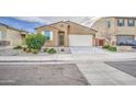Well-maintained single Gathering home showcasing desert landscaping, two-car garage, and inviting facade at 23649 W Watkins St, Buckeye, AZ 85326