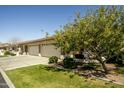 Attractive home with a three-car garage, lovely landscaping, and a cozy front sitting area at 2663 S Springwood Blvd # 326, Mesa, AZ 85209