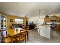 Bright, open-concept living room with dining area, granite countertop bar, and views of the golf course at 2663 S Springwood Blvd # 326, Mesa, AZ 85209