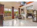 Spacious room with large windows, stylish curtains, and a glimpse of the fireplace at 3713 E Cat Balue Dr, Phoenix, AZ 85050