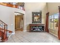 Bright living room featuring tile floors, custom shelving, and large windows at 3713 E Cat Balue Dr, Phoenix, AZ 85050