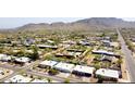 Expansive aerial view of a residential neighborhood surrounded by desert landscape and mountains in the background at 4001 E Cannon Dr, Phoenix, AZ 85028