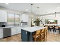 Modern kitchen featuring a large island with seating, pendant lighting, and stainless steel appliances at 4216 N 42Nd St, Phoenix, AZ 85018