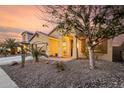 Inviting home featuring desert landscaping, concrete driveway, and a charming covered porch at 43298 W Delia Blvd, Maricopa, AZ 85138