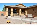 Welcoming front porch featuring desert landscaping and a cozy bench at 45558 W Mountain View Rd, Maricopa, AZ 85139