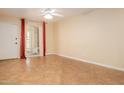 Open-concept living area with tile flooring, ceiling fan and access to modern window and front door at 4730 W Northern Ave # 1158, Glendale, AZ 85301