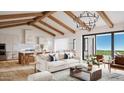 Open-concept living room with exposed beams, contemporary lighting, and seamless indoor-outdoor flow at 502 E Tanglewood Trl, Phoenix, AZ 85085