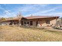 Elegant home features a spacious porch, a well-maintained lawn, and a peaceful rural setting at 51238 N Pinal Ranch Rd, Miami, AZ 85539