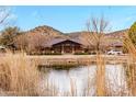 Beautiful home overlooking a tranquil pond and surrounded by picturesque scenery and natural beauty at 51238 N Pinal Ranch Rd, Miami, AZ 85539
