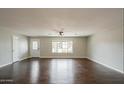 Spacious living room with hardwood floors and a large window, providing ample natural light at 6820 E Pinchot Ave, Scottsdale, AZ 85251