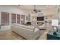 Inviting living room with high ceilings, natural light, a cozy fireplace, and stylish decor at 9612 W Mariposa Grande --, Peoria, AZ 85383