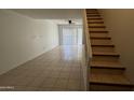 Open floor plan living room with tile flooring, white walls and large windows at 1215 E Lemon St # 212, Tempe, AZ 85281