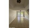 Spacious living room with tile flooring, fan and sliding glass door at 1215 E Lemon St # 212, Tempe, AZ 85281