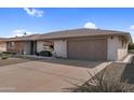 This home features a desert landscaped front yard and a two-car garage with a long driveway at 13235 W Ashwood Dr, Sun City West, AZ 85375