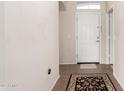 Inviting foyer with neutral walls, tiled floor, a decorative rug and a white front door at 1339 E Silverbrush Trl, Casa Grande, AZ 85122