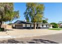 Lovely home with an attached two car garage, stylish black and white exterior, and gravel landscaping at 1504 E Jasmine St, Mesa, AZ 85203