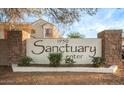 Stone sign for the 'Sanctuary Center' community set among desert landscaping at 1950 N Center St # 111, Mesa, AZ 85201