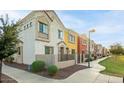 Street view of colorful townhomes featuring small gated courtyards and desert landscaping at 1950 N Center St # 111, Mesa, AZ 85201