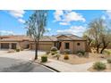 Attractive single-story home featuring a three-car garage and drought-tolerant landscaping at 2025 W Calle Del Sol --, Phoenix, AZ 85085