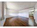 Bright living room featuring wood-look flooring, a window, and neutral paint at 2144 W Joan De Arc Ave, Phoenix, AZ 85029