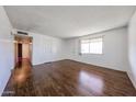 Open living area featuring wood-look floors, white walls and ample natural light at 2144 W Joan De Arc Ave, Phoenix, AZ 85029