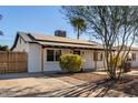 Inviting home featuring a well-manicured lawn, solar panels, complemented by a welcoming entrance and landscaping at 2205 N 22Nd St, Phoenix, AZ 85006