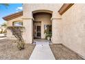 Inviting front entrance with stone pathway, potted plant, security door and arched porch at 22503 N 76Th Pl, Scottsdale, AZ 85255