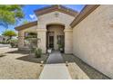 Close-up of home's entryway showcasing front door and desert landscaping at 22503 N 76Th Pl, Scottsdale, AZ 85255