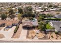 Wide aerial shot showcasing the home's landscaping, solar panels, in-ground pool and neighborhood at 3419 E Cholla St, Phoenix, AZ 85028