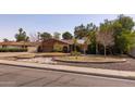 Charming single-story home featuring landscaped front yard, arched entryway, and desert landscaping at 3419 E Cholla St, Phoenix, AZ 85028