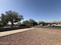 Quiet street view with mature trees, sidewalks and gravel front yard at 4221 N 33Rd Dr, Phoenix, AZ 85017