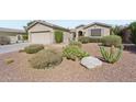 Single-story home with a well-maintained desert rock front yard, showcasing drought-tolerant landscaping at 42808 W Whimsical Dr, Maricopa, AZ 85138