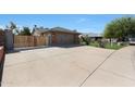 Long driveway leading to a two-car garage with brick accents and a privacy gate at 6431 W Monte Cristo Ave, Glendale, AZ 85306