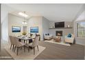 Open-concept living room with modern decor and a cozy fireplace, perfect for relaxing and entertaining guests at 6431 W Monte Cristo Ave, Glendale, AZ 85306