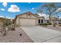 Attractive home with a spacious driveway, desert landscaping and two-car garage at 6664 W Rose Garden Ln, Glendale, AZ 85308