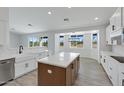 Well-lit kitchen featuring a large island, modern appliances, and views of the desert landscape at 740 W Patrick Pl, San Tan Valley, AZ 85143