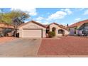 Single story home with desert landscaping, garage and a well maintained front yard at 9230 W Charleston Ave, Peoria, AZ 85382