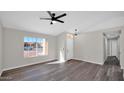 Bright and airy living room with wood-look floors, ceiling fan and natural light at 9230 W Charleston Ave, Peoria, AZ 85382