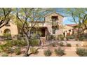 Stone home with an outdoor sitting area and mature landscaping at 9282 E Desert Vw, Scottsdale, AZ 85255