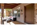 Inviting front porch featuring comfortable seating and a stylish entrance door at 9282 E Desert Vw, Scottsdale, AZ 85255