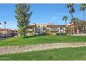 Exterior shot of the building featuring palm trees and a well-maintained lawn at 10410 N Cave Creek Rd # 1032, Phoenix, AZ 85020